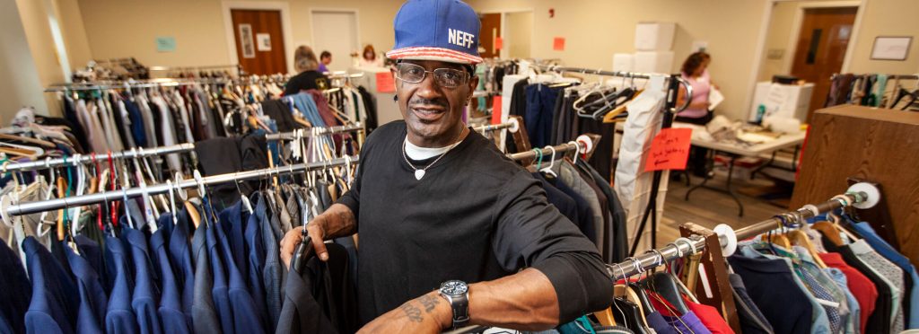 Craig Henry poses in the Thread of Life Thrift Store in Whitesboro, NY