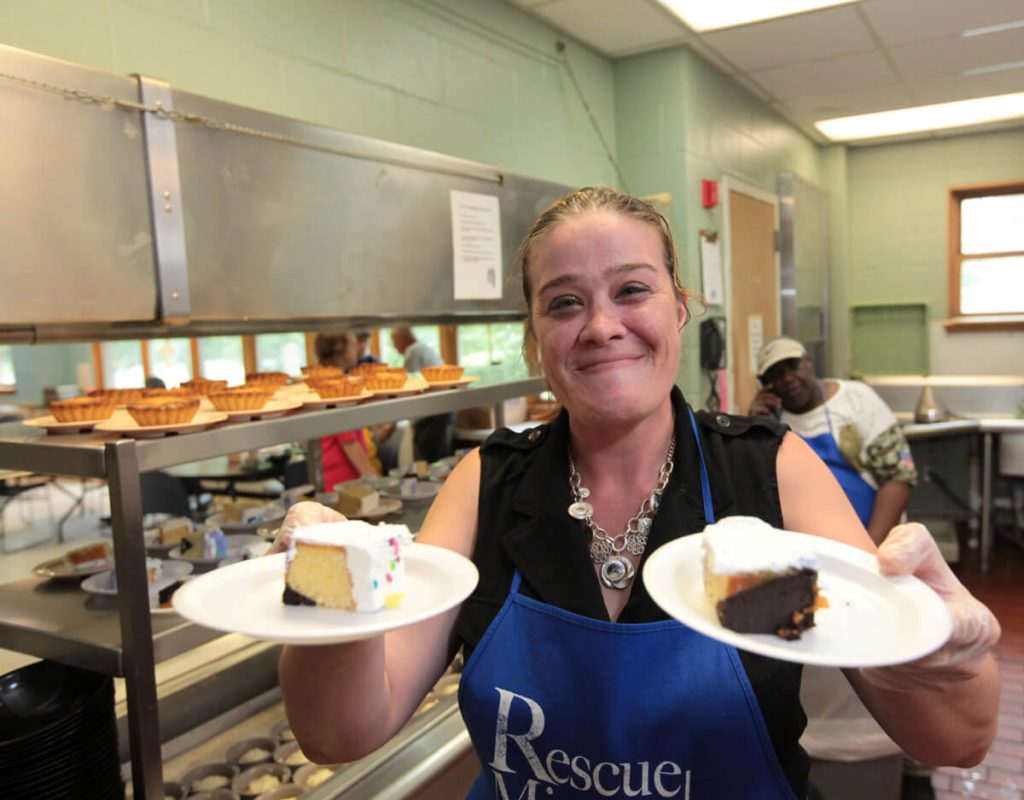Jennifer Castle serves treats at the food service program for Rescue Mission of Utica in New York.